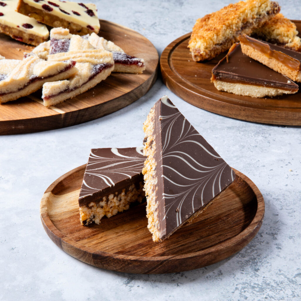 Assorted dessert slices on wooden plates